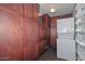 Laundry Room featuring full size stacked washer and dryer, lots of cabinets, and wire shelving at 6041 E Colby St, Mesa, AZ 85205