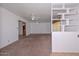 Spacious living room features neutral carpet, a ceiling fan, and stylish built-in shelving at 6041 E Colby St, Mesa, AZ 85205