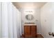 Bathroom featuring neutral walls, wood cabinets, and shower curtain at 617 W Gibraltar Ln, Phoenix, AZ 85023