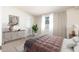 Bright bedroom features neutral walls, gray bedding and contemporary furnishings at 617 W Gibraltar Ln, Phoenix, AZ 85023