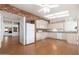 Spacious kitchen featuring white appliances, lots of storage and adjacent dining area at 617 W Gibraltar Ln, Phoenix, AZ 85023