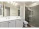Modern bathroom featuring a dual sink vanity and a glass-enclosed shower with gray tile at 7343 E Casitas Del Rio Dr, Scottsdale, AZ 85255