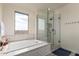 Elegant bathroom with a luxurious bathtub, glass-enclosed shower, and stylish tile work, creating a spa-like experience at 7343 E Casitas Del Rio Dr, Scottsdale, AZ 85255