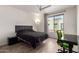 Contemporary bedroom with a dark bedspread, hardwood floors, and a bright window, offering a modern retreat at 7343 E Casitas Del Rio Dr, Scottsdale, AZ 85255