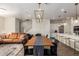 Open-concept living space with dining area, leather sofa, and staircase at 7343 E Casitas Del Rio Dr, Scottsdale, AZ 85255