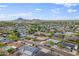 Panoramic aerial view of neighborhood featuring diverse homes, lush greenery, and scenic mountain backdrop at 8222 E Sheridan St, Scottsdale, AZ 85257