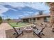 Lush backyard with a fire pit and Adirondack chairs, perfect for outdoor gatherings and relaxation at 8222 E Sheridan St, Scottsdale, AZ 85257