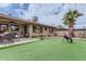 Spacious backyard with putting green, a patio, and a well-maintained lawn at 8222 E Sheridan St, Scottsdale, AZ 85257