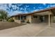 View of the covered carport featuring a gated entry and a welcoming front porch at 8222 E Sheridan St, Scottsdale, AZ 85257