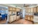 Cozy kitchen features wood floors, stainless steel appliances, wood cabinets and tiled backsplash at 8222 E Sheridan St, Scottsdale, AZ 85257