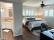 Bright main bedroom features wood floors, ceiling fan, and ensuite bathroom at 8222 E Sheridan St, Scottsdale, AZ 85257
