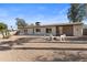 A large backyard with desert landscaping, seating areas, and a modern home in a desirable location at 845 E Village Circle S Dr, Phoenix, AZ 85022