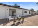 Backyard featuring comfortable seating, a covered patio, desert landscaping, and stylish white accents at 845 E Village Circle S Dr, Phoenix, AZ 85022