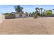 Expansive gravel backyard featuring a modern home with a neutral color palette, seating areas and a privacy wall at 845 E Village Circle S Dr, Phoenix, AZ 85022