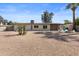 Wide backyard featuring desert landscaping, a covered patio, and a modern home design with a neutral palette at 845 E Village Circle S Dr, Phoenix, AZ 85022