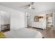 Bright bedroom featuring light wood floors, modern decor, and ensuite bathroom at 845 E Village Circle S Dr, Phoenix, AZ 85022