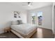 Bright bedroom with modern ceiling fan, windows overlooking the front yard, and closet at 845 E Village Circle S Dr, Phoenix, AZ 85022