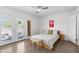 Bright bedroom featuring light wood floors, ceiling fan, and french doors to the outdoors at 845 E Village Circle S Dr, Phoenix, AZ 85022