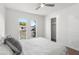 Bright bedroom with modern ceiling fan, windows overlooking the front yard, and closet at 845 E Village Circle S Dr, Phoenix, AZ 85022