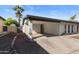 Exterior of a home highlighting its covered carport, xeriscaped yard, and clean, modern design at 845 E Village Circle S Dr, Phoenix, AZ 85022
