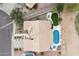 Aerial view of the backyard with a pool, spa, covered patio, and desert landscaping at 8542 W Rosemonte Dr, Peoria, AZ 85382