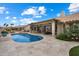 Backyard with an in-ground pool, covered patio, and lush landscaping creating a perfect outdoor retreat at 8542 W Rosemonte Dr, Peoria, AZ 85382