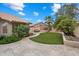 Secluded backyard featuring a manicured lawn, mature trees, and travertine pavers for easy maintenance at 8542 W Rosemonte Dr, Peoria, AZ 85382