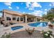 Beautiful backyard with an in-ground pool, jacuzzi, covered patio, and well manicured landscaping at 8542 W Rosemonte Dr, Peoria, AZ 85382