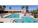 Large community pool area with a lap pool, wading pool, and lounge chairs at 8542 W Rosemonte Dr, Peoria, AZ 85382