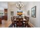 Elegant dining room featuring a chandelier, hardwood floors, and ample natural light at 8542 W Rosemonte Dr, Peoria, AZ 85382