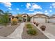 Charming home featuring a well-manicured front yard with stone walkway, flowers, and a two-car garage at 8542 W Rosemonte Dr, Peoria, AZ 85382