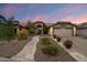 Charming home features manicured landscaping, a welcoming walkway, and an attached two-car garage at 8542 W Rosemonte Dr, Peoria, AZ 85382