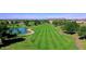 Scenic view of a lush green golf course with a pond at 8542 W Rosemonte Dr, Peoria, AZ 85382
