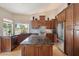 Beautiful kitchen with an island, dark wood cabinets, stainless steel appliances, and a breakfast bar at 8542 W Rosemonte Dr, Peoria, AZ 85382