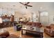 Open-concept living area featuring hardwood floors, a large ceiling fan, and views to the dining area and kitchen at 8542 W Rosemonte Dr, Peoria, AZ 85382