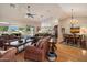 Spacious living area with hardwood floors that integrates the dining area and flows to the outdoor pool at 8542 W Rosemonte Dr, Peoria, AZ 85382