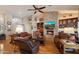 Inviting living room with a stone fireplace, hardwood floors, and comfortable leather furnishings at 8542 W Rosemonte Dr, Peoria, AZ 85382