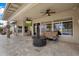 Inviting covered patio with ceiling fans, comfortable seating, and a cozy fire pit for outdoor gatherings at 8542 W Rosemonte Dr, Peoria, AZ 85382