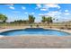 A refreshing in-ground pool with a tiled edge and travertine surround, overlooking a lush green golf course at 8542 W Rosemonte Dr, Peoria, AZ 85382