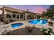A luxurious backyard boasts a pristine pool, spa, and a covered patio perfect for entertaining at 8542 W Rosemonte Dr, Peoria, AZ 85382