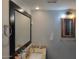 Bathroom featuring granite-look vanity, modern sink, and decorative framed mirror at 921 S Val Vista Dr # 28, Mesa, AZ 85204