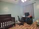 Bedroom with a crib, desk, and laminate flooring at 921 S Val Vista Dr # 28, Mesa, AZ 85204