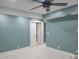 Open-concept bedroom with white tile, fan, and view into hall at 921 S Val Vista Dr # 28, Mesa, AZ 85204