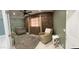 Charming Bedroom with exposed brick, a rocking chair, crib, and window, creating a cozy atmosphere at 921 S Val Vista Dr # 28, Mesa, AZ 85204