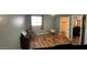 Bedroom with wood floors, bright window and adjacent closet/bathroom at 921 S Val Vista Dr # 28, Mesa, AZ 85204