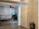 Bedroom with neutral paint and ceiling fan, with view into adjacent room at 921 S Val Vista Dr # 28, Mesa, AZ 85204
