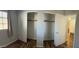 Bedroom with sliding closet doors and wood-look flooring, providing ample storage space at 921 S Val Vista Dr # 28, Mesa, AZ 85204