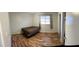 Bright bedroom featuring wood-look flooring, a window, and closet for comfortable living at 921 S Val Vista Dr # 28, Mesa, AZ 85204
