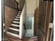 Inviting entryway featuring a staircase, brick accents, and wood-look floors at 921 S Val Vista Dr # 28, Mesa, AZ 85204