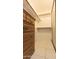 Walk-in closet with white shelving, accompanied by a wooden dresser with vintage hardware at 921 S Val Vista Dr # 28, Mesa, AZ 85204